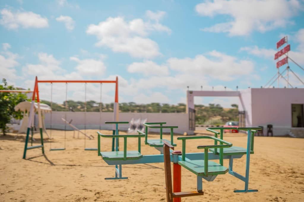 Playground in front of the Hotel Jaisalmer Desert sign and camp gate