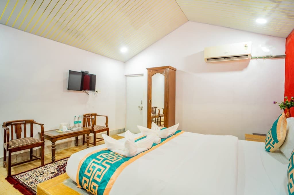 Hotel bedroom in Jaisalmer with a wall-mounted television and split air conditioner